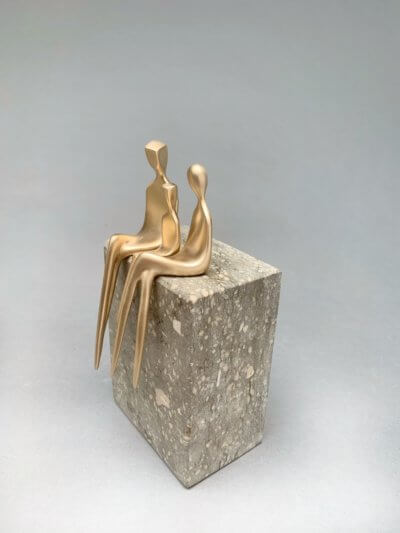 family of three with baby boy sculpture