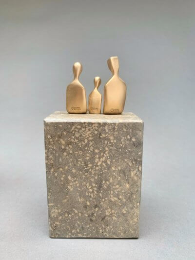 family of three with baby boy sculpture