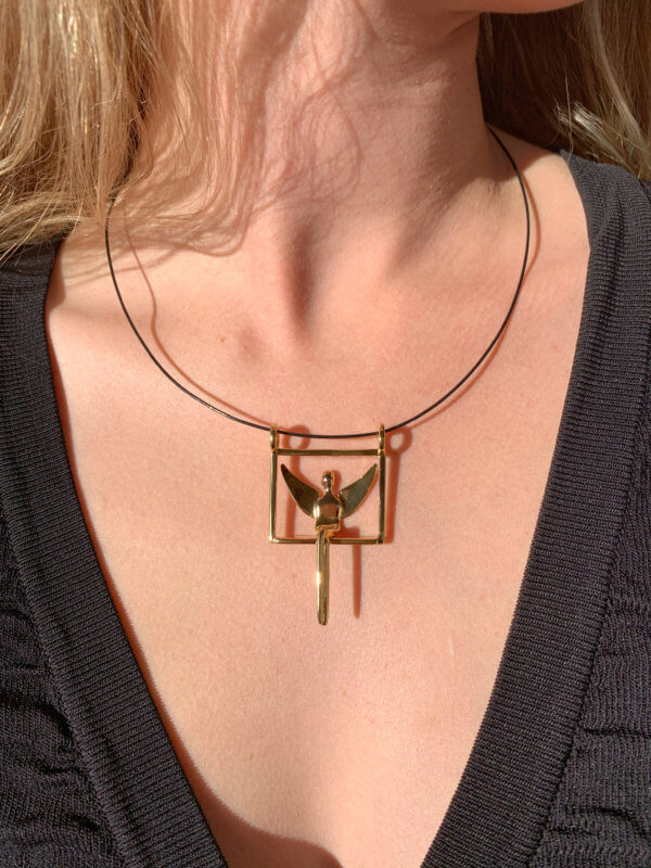 Woman wearing gold angel pendant