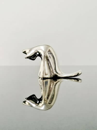 silver grooming cat sculpture