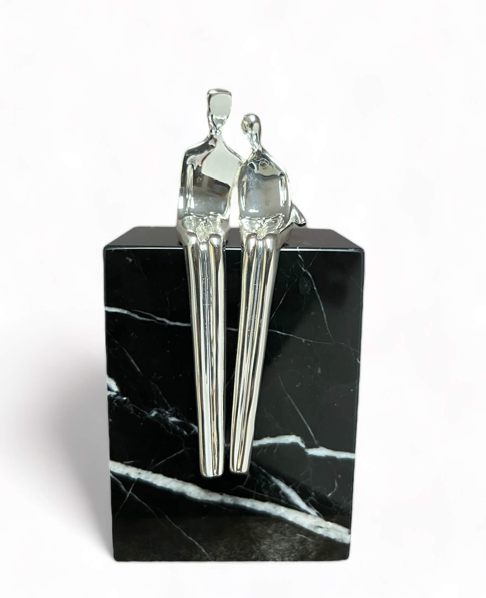 Seated couple sculpture in silver, lovers snuggled together side by side a 25th anniversary gift