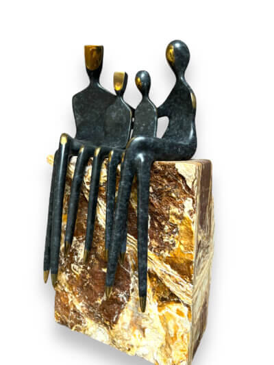 Unique bronze sculpture family of four in speckled gray patina mounted on Travertine side view