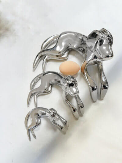 Three dogs in stainless steel sculpture