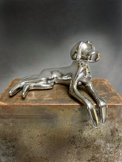 10" lying down dog sculpture in polished stainless steel