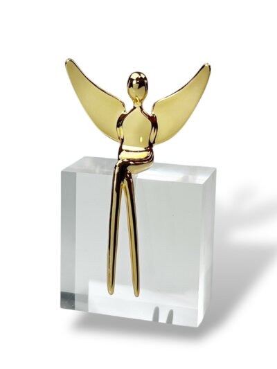 Gold angel figurine on crystal clear stand